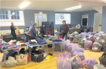  ??  ?? Aid Volunteers sort out donations at a previous collection in the White Church organised by Comrie Cares