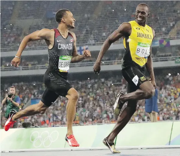  ?? — THE CANADIAN PRESS ?? Andre De Grasse and Usain Bolt enjoy their run in the men’s 200-metre semifinal at the Rio Olympics Wednesday.