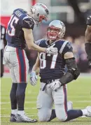  ?? STAFF PHOTO BY MATT STONE ?? BIG CONCERN: Chris Hogan (15) checks on Rob Gronkowski after a helmet-to-helmet hit in the Patriots’ AFC title game win yesterday at Gillette Stadium.