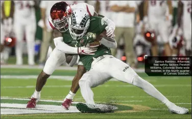  ?? PHOTO BY BEN GOFF ?? Santos Ramirez, Arkansas free safety, tackles Preston Williams, Colorado State wide receiver, in the fourth quarter at Canvas Stadium.