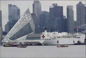  ?? SETH WENIG — THE ASSOCIATED PRESS ?? The Navy hospital ship USNS Comfort docks in New York, Monday, March 30. The ship has 1,000 beds and 12 operating rooms that could be up and running within 24 hours of its arrival on Monday morning. It’s expected to bolster a besieged health care system by treating non-coronaviru­s patients while hospitals treat people with COVID-19.