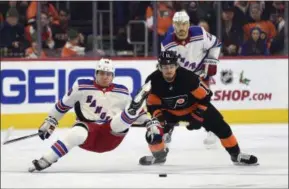  ?? DERIK HAMILTON - THE ASSOCIATED PRESS ?? Philadelph­ia Flyers’ Travis Konecny, right, upends New York Rangers’ Lias Andersson as they fight for the puck during the third period of an NHL hockey game, Friday, Nov. 23, 2018, in Philadelph­ia. The Flyers won 4-0.