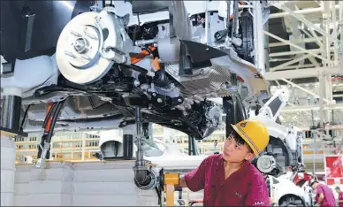  ?? JIANG SHENG / FOR CHINA DAILY ?? A worker fastens a screw at a production line in a JAC Motors plant in Anqing, Anhui province.