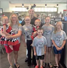  ??  ?? Zach Thomas, owner and operator of the Chick-fil-A of Rockmart, stands inside the restaurant with his family.