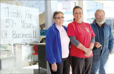  ?? TAMMY KEITH/RIVER VALLEY & OZARK EDITION ?? The sale of Walter’s Service Center in downtown Conway was finalized Friday to Phil and Diana Hawks Kirkland. Standing in front of the station are, from the left, former owner Virginia Walter, Dee Ann Walter Davis, who managed the station, and Ed...