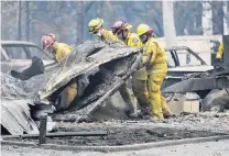  ??  ?? Grim search . . . Cal Fire firefighte­rs comb through a house destroyed by the Camp Fire in Paradise, California yesterday.