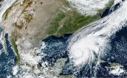  ?? PHOTO: HANDOUT VIA REUTERS ?? Hurricane Ian makes its way to Florida's west coast after passing Cuba in a composite image from the National Oceanic and Atmospheri­c Administra­tion’s weather satellite last week.