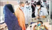  ?? HT PHOTO ?? Uttar Pradesh CM Yogi Adityanath visits ailing children at the district hospital and reviews arrangemen­ts.