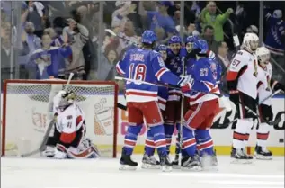  ?? FRANK FRANKLIN II, THE ASSOCIATED PRESS ?? Rangers players celebrate Michael Grabner’s second-period goal that gave them a 2-0 lead Tuesday night in New York.