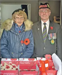  ?? 25_c45poppyse­lling01 ?? Richard Cameron, Campbeltow­n’s Poppy Convenor for Poppy Scotland, was assisted by Flora Edwards as they sold poppies and wooden crosses in advance of Remembranc­e day.