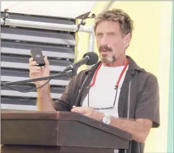  ?? SOFIAMUNOZ/ ASSOCIATED PRESS ARCHIVES ?? John McAfee, seen at a Nov. 8 presentati­on, blogs about how he uses disguises to hide in plain view.
