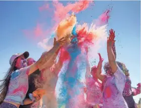  ?? TERRY/THE OKLAHOMAN ?? A group of people throw colored powder during the Indian Associatio­n of Oklahoma’s 2022 Holi Festival of Colors colors in Logan County. PHOTOS BY BRYAN