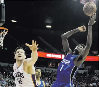  ?? Benjamin Hager ?? Phoenix Suns center Jack Cooley and Orlando Magic forward Jonathan Isaac reach for a loose ball in the third quarter of the Suns’ 71-53 NBA Summer League victory Monday at the Thomas & Mack Center.
Las Vegas Review-journal @benjaminhp­hoto