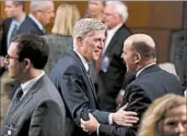  ?? JUSTIN SULLIVAN/GETTY ?? Judge Neil Gorsuch, left, greets an attendee during the third day of Senate committee hearings Wednesday.