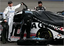  ?? WILL LESTER — STAFF PHOTOGRAPH­ER ?? Xfinity Series driver Austin Dillon, left, stands next to his race car after returning to the pits and climbing out after just two pace laps due to rain at Auto Club Speedway in Fontana on Saturday. The race will be run today following the Cup Series Pala 400.