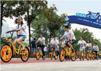  ??  ?? September 15, 2017: Volunteers ride bicycles in a park in Chongqing Municipali­ty to promote green travel and low carbon practices. by Zhou Yi/china News Service/vcg