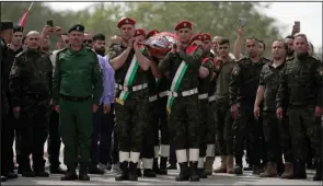  ?? (AP/Majdi Mohammed) ?? Slain Al Jazeera veteran journalist Shireen Abu Akleh is carried by a Palestinia­n honor guard Wednesday in the West Bank city of Nablus.