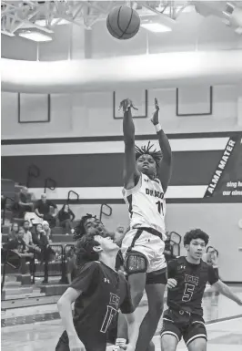  ?? PHOTOS BY HENRY HUEY/SPECIAL TO AMERICAN-STATESMAN ?? ABOVE: Andre Griffin puts up a shot for Round Rock, which beat Cedar Ridge 56-35 Friday to secure a postseason berth. BELOW: Jonathan Wenthe and Mason Cochran of Round Rock and Sam Fielding of Cedar Ridge battle for a loose ball.