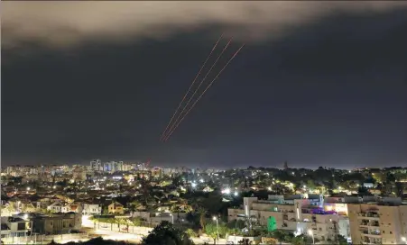  ?? AMIR COHEN / REUTERS ?? An Israeli anti-missile system intercepts drones and missiles launched by Iran, as seen on Sunday from Ashkelon, Israel.
