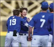  ?? (Special to the NWA Democrat-Gazette/David Beach) ?? Rogers’ J.T. Melson (middle) celebrates with teammates after hitting a game-winning single to help the Mounties to a 2-1 victory against Springdale Har-Ber on Monday in Rogers. For more photos, see arkansason­line.com/426basebal­l/