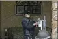  ??  ?? A worker adds hand sanitizer to a hygiene station on Friday at the Life Care Center in Kirkland, Wash., which has become the epicenter of the COVID-19 coronaviru­s outbreak in Washington state.