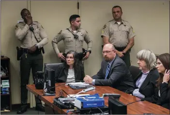  ?? GINA FERAZZI/LOS ANGELES TIMES ?? Seated at the table are Louise Turpin, left, and David Turpin, second from right, plead not guilty to charges of multiple counts of torture, child abuse, abuse of dependent adults and false imprisonme­nt, during an arraignmen­t at the Riverside Hall of...