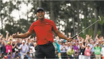  ?? David J. Phillip / Associated Press 2019 ?? Tiger Woods, the defending champion, is among the players who has fond memories of loud crowds at the Masters. Because of COVID19, no fans will be at the tournament this week.