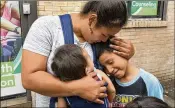 ?? RICHARD DREW / ASSOCIATED PRESS ?? Eilyn Carbajal reunites with her children in August at the Cayuga Center in New York. Immigrant families are facing tougher rules to take custody of children and relatives who crossed the U.S. border.