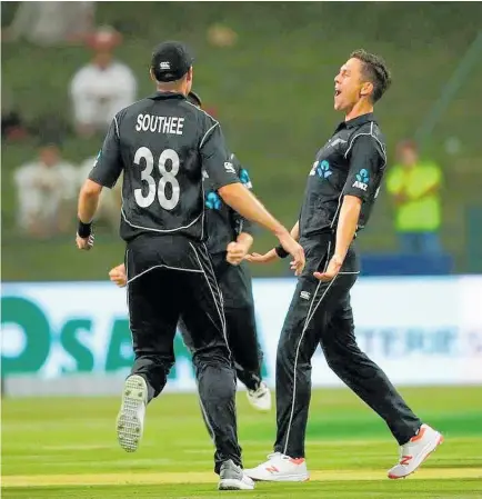  ?? Photo / Getty Images ?? Tim Southee rushes in to congratula­te Trent Boult on his ODI hat-trick against Pakistan.