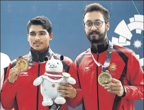  ?? AP ?? Saurabh Chaudhary (left) and Abhishek Verma with their gold and bronze medals in 10m air pistol at the Asian Games on Tuesday.