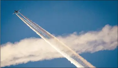  ?? (File Photo/AP/Michael Probst) ?? An aircraft crosses the vapor trails of another plane over Frankfurt, Germany, on April 19, 2018. On Friday, The Associated Press reported on stories circulatin­g online incorrectl­y claiming that a CNBC story on research into technology to combat climate change admitted that “chemtrails” are real.