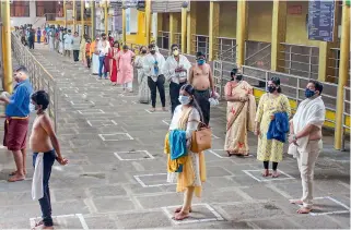  ?? — PTI ?? Devotees maintain social distance while standing in a queue to pay obeisance at Kukke Subramanya Temple in Dakshina Kannada on Monday after religious places reopened with certain restrictio­ns, during the fifth phase of ongoing Covid-19 lockdown.