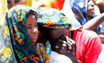  ?? — Reuters photo ?? Relatives mourn as they attend the burial of dead passengers retrieved after the MV Nyerere ferry overturned off the shores of Ukara Island in Lake Victoria, Tanzania.