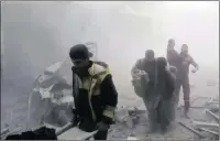  ?? PICTURE: AP ?? Members of the Syrian Civil Defence group the White Helmets help residents during shelling by Syrian government forces in Ghouta.
