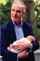  ??  ?? Tender and caring: Anthony cradles baby Ottilie