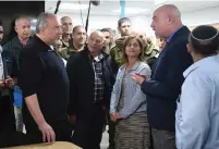  ??  ?? DEFENSE MINISTER Avigdor Liberman (left) visits residents of Katzrin on the Golan Heights yesterday.