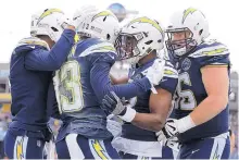  ?? KAREEM ELGAZZAR/THE CINCINNATI ENQUIRER VIA AP ?? Los Angeles wide receiver Keenan Allen (13) celebrates with teammates after scoring a touchdown in the Chargers’ win over the Bengals Sunday.