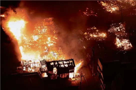  ?? YOMIURI SHIMBUN/AFP VIA GETTY IMAGES ?? Buildings burned Monday in the city of Wajima, Ishikawa prefecture, after a major earthquake struck the Noto Peninsula.