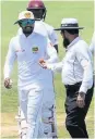  ??  ?? row Aleem Dar shows the ball to Dinesh Chandimal