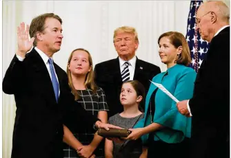  ?? CHIP SOMODEVILL­A / GETTY IMAGES ?? Supreme Court Justice Brett Kavanaugh takes part Monday in a ceremonial swearing-in at the White House with President Donald Trump and retired Justice Anthony Kennedy. To Kavanaugh’s left are his daughters Margaret and Liza, and his wife, Ashley.