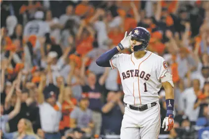  ?? PHOTOS BY MATT SLOCUM/ASSOCIATED PRESS ?? Astros shortstop Carlos Correa celebrates after his walk-off home run against the Yankees during the 11th inning in Game 2 of the American League Championsh­ip Series on Sunday in Houston.