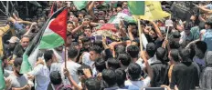  ?? Mahmud Hams / Getty Images ?? Palestinia­n mourners carry the casket of Razan Najjar in Khan Yunis after she was shot dead by Israeli soldiers, Palestinia­n medical sources said, near the Gaza border fence on Friday.