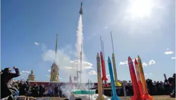  ?? — AFP ?? Bystanders watch the launch of model rockets near The Peter and Paul Fortress in Saint Petersburg during a celebratio­n of the 60th anniversar­y of Russia’s Yuri Gagarin’s first manned flight into space.