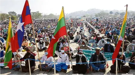  ?? — AFP ?? Picking a side: Army supporters waving the national flag as well as the armed forces of Myanmar flag during a rally in Naypyidaw following the coup.