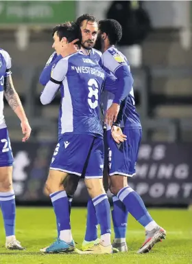  ??  ?? Zain Westbrooke is congratula­ted on scoring Rovers’ third goal