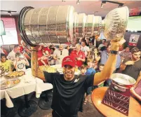  ?? STEVE RUSSELL TORONTO STAR FILE PHOTO ?? Former Chicago Blackhawk Ray Emery brings the Stanley Cup to Wayne Gretzky's restaurant in Toronto in 2013.