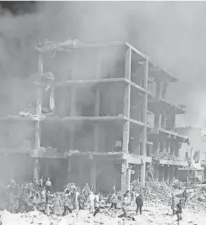  ?? SANA HANDOUT, EPA ?? A bombed out building smolders following an explosion Wednesday in Qamishli, Syria. The Islamic State has claimed responsibi­lity for the attack.