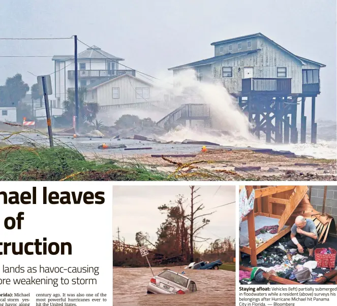  ?? — Reuters ?? Force of nature: Waves crashing on stilt houses along the shore as Hurricane Michael stirs up storm surges at Alligator Point in Franklin County, Florida.