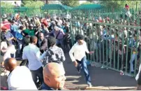  ??  ?? BREAKOUT: A few students climbed the fence to get in, which then snowballed into a stampede which forced security guards to open the gates.