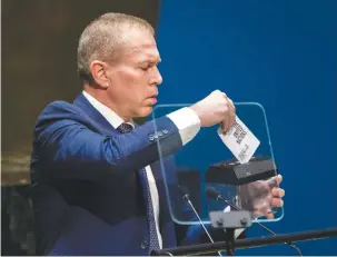  ?? (Eduardo Munoz/Reuters) ?? ISRAEL’S AMBASSADOR to the United Nations, Gilad Erdan, shreds the United Nations Charter during the General Assembly session that voted on Friday to recognize that Palestine has qualified to become a full UN member.